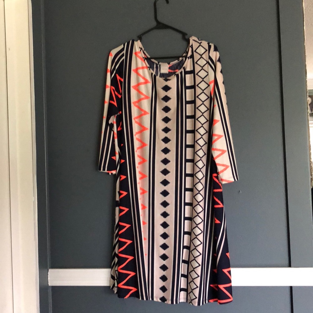 dress with red and black designs, cream base color